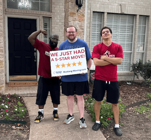 Mustang Moving customer Richard R. with two crew members in front of his home.