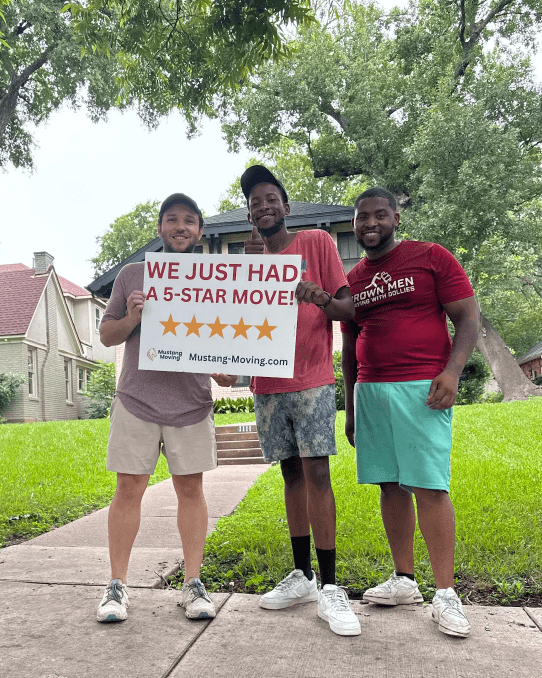 Mustang Moving customer Vivian M. with three crew members holding a 5-star move sign in front of a Dallas home.