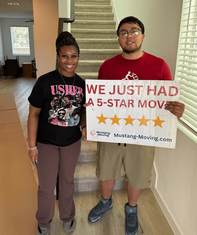 Mustang Moving customer Imani R. with a crew member at the foot of a townhome staircase.