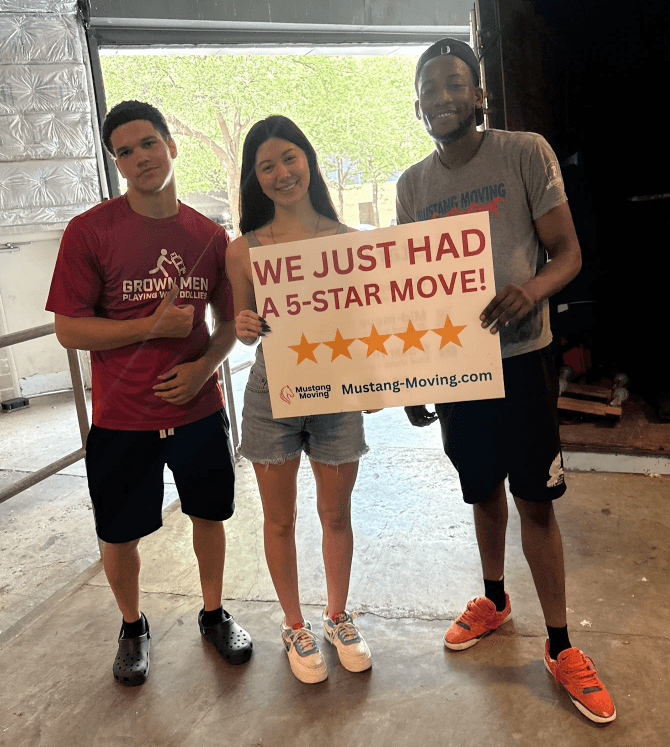 Mustang Moving customer Priya S. with two crew members at the warehouse.
