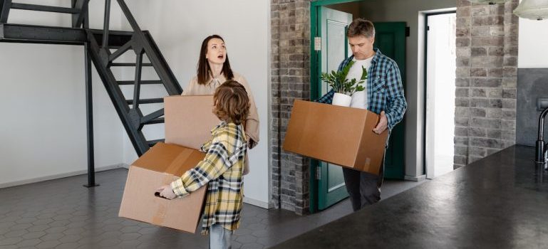 A family moving into an apartment after getting help from The Colony movers.